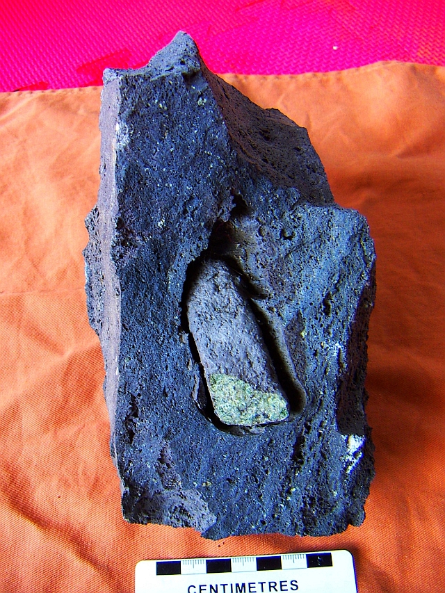a piece of the mantle, peridotie xenolith  in basalt lava